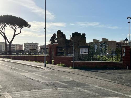 an empty street next to a building with a fence at VillaRussoRoma in Rome