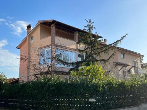 a pink house with a tree in front of it at VillaRussoRoma in Rome
