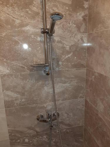 a shower in a bathroom with a glass door at Lux Apartment Вокзал. Надежды Алексеенко 30 in Dnipro