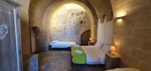 Ένα ή περισσότερα κρεβάτια σε δωμάτιο στο Sassi Dream Matera