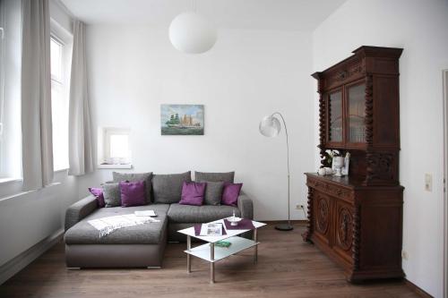 a living room with a couch and a table at Appartements am Markt in Greifswald