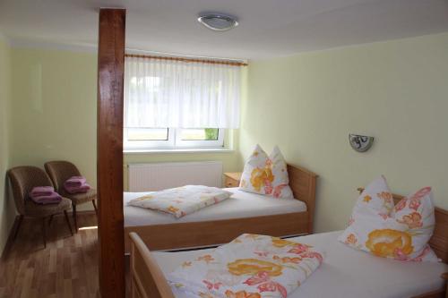 a room with two beds and a window at Ferienhaus _Erika_ Familie Meier in Boldekow