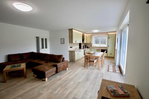 a living room with a couch and a table at Hirschhof in Hohendorf