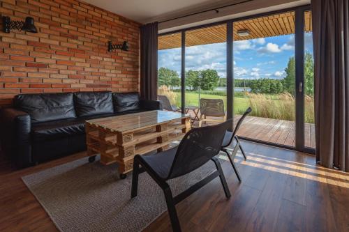 a living room with a couch and a table and chairs at Glemuria in Kętrzyn