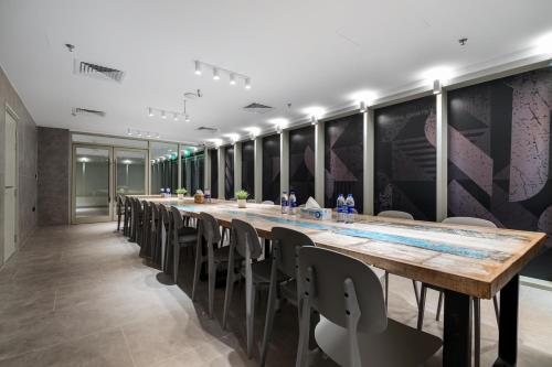 a long conference room with a long table and chairs at Emirates Sports Hotel, Dubai Sports City in Dubai