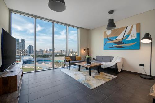 a living room with a view of a city at Emirates Sports Hotel Apartments, Dubai Sports City in Dubai