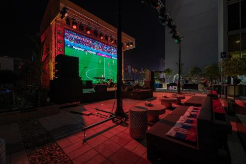 a stage with a video game on a screen at night at Emirates Sports Hotel, Dubai Sports City in Dubai