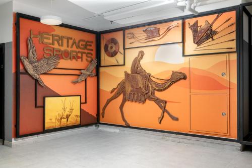 a room with a wall covered in science exhibits at Emirates Sports Hotel, Dubai Sports City in Dubai