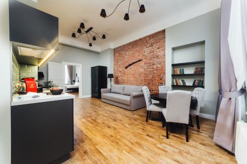 a kitchen and living room with a brick wall at Sherlock Apartments in Rīga