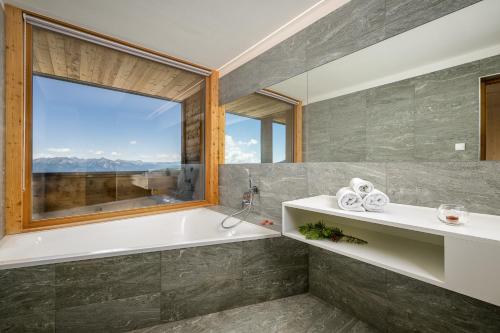 羅登格的住宿－Starkenfeldhütte，带浴缸和窗户的浴室