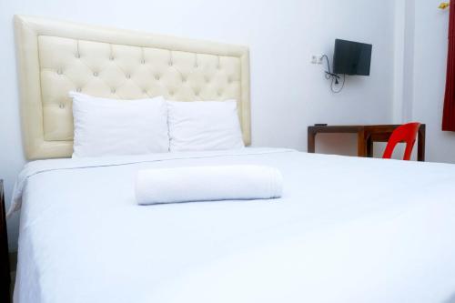מיטה או מיטות בחדר ב-Fortuner Homestay Syariah Makassar Mitra RedDoorz