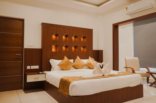 a bedroom with a large bed with a wooden headboard at Sprise Munnar Resort and Spa in Munnar