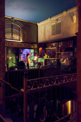 a restaurant with people sitting at a bar at night at Gwuni Mopera in Leipzig