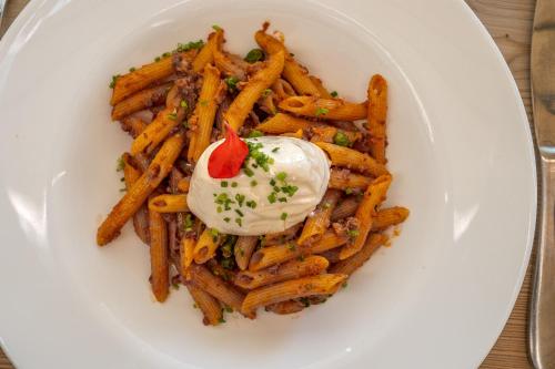 a plate of french fries with a dollop of sour cream at Starkenfeldhütte in Rodengo