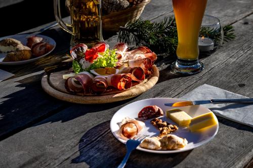 a table with plates of food and a bowl of food at Starkenfeldhütte in Rodengo