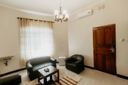 a living room with two chairs and a couch at Panama Garden Resort in Moshi