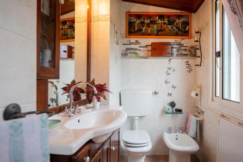 a bathroom with a toilet and a sink at HelloElba Appartamento Il Borgo in Marciana