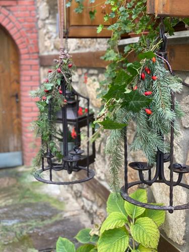 a pair of black lanterns with christmas plants on a wall at Urban River House in Florina