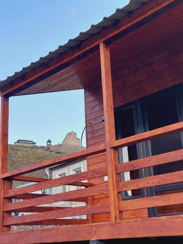 a wooden fence on the side of a building at Guesthouse and Cottage Nicolo in Stepantsminda
