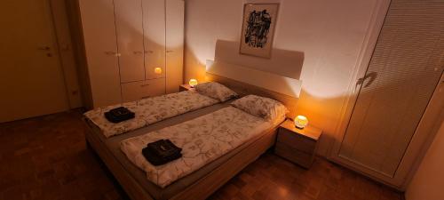 um pequeno quarto com uma cama com duas velas em Thomas apartment 028 em Ljubljana