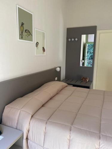a bedroom with a large white bed in a room at Locanda La Cavallina in Brisighella