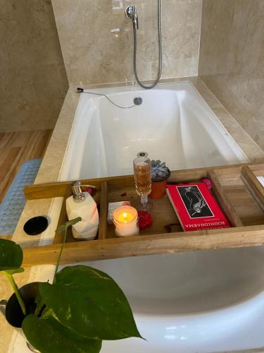 a bath tub with a candle and a candle holder in it at 11 Monteviot: Luxury homestay overlooking a tea estate in Kurseong