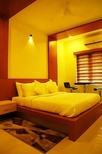 a bedroom with a large bed and a window at Sea Breeze Rest Inn in Kannur