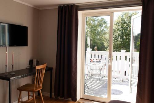 a sliding glass door leading to a patio with a table at Hotell Magasin 1 in Mörbylånga