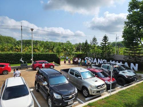 a group of cars parked in a parking lot at ภูฝ้ายวิลล่า Phufai villa in Chiang Khan