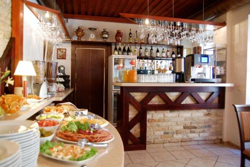 a restaurant with a buffet with plates of food at City Gate in Vilnius