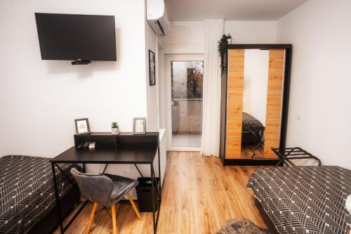 a bedroom with a desk and a bed and a mirror at LaRoom - Free Parking in Zagreb