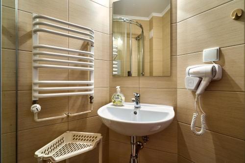 a bathroom with a sink and a mirror at Goga in Zakopane