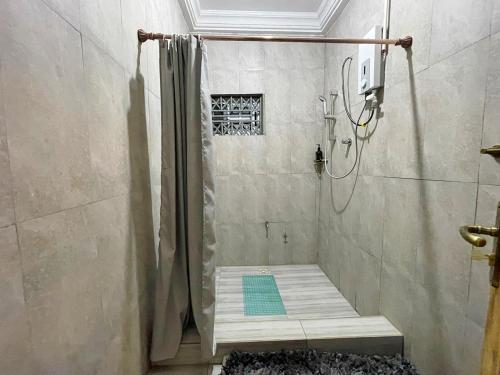 a bathroom with a shower with a shower curtain at Tamani - Your home away from home in Tamale