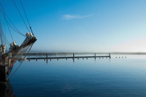 a boat sitting in the water with a dock at Haus Borgwardt im Ostseebad Göhren in Göhren