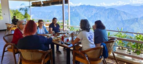 a group of women sitting at a table in a restaurant at The Rudraksh, A Himalayan Retreat in Kandikhal