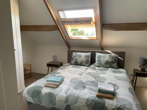 a bedroom with a bed with pillows and a window at Appartement 5 in Vrouwenpolder
