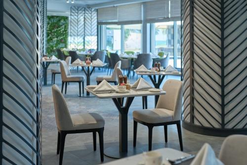 a row of tables and chairs in a restaurant at Hotel Holiday International in Sharjah