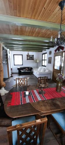 a living room with a table and a couch at Baladă de Rarău in Câmpulung Moldovenesc