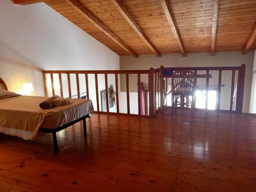 a bedroom with a bed and a wooden floor at Sal&Love apt in Porto Antigo in Santa Maria
