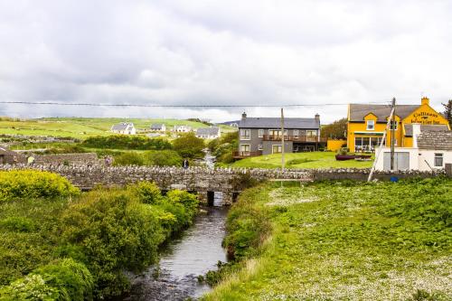 a small village with a bridge and a river at Doolin Eye Dunroman in Doolin