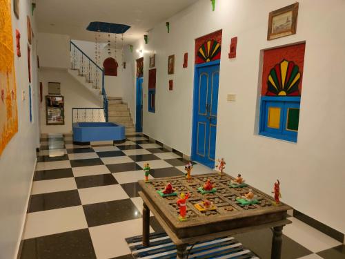 um quarto com uma mesa num piso xadrez em Bhavyam Heritage Guest House em Jodhpur