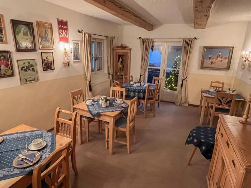 a dining room with tables and chairs and a window at Koller, Pension Haus in Kitzbühel