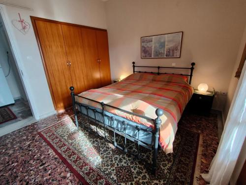 a bedroom with a bed and a wooden door at Anna's house 2 in Psakoudia
