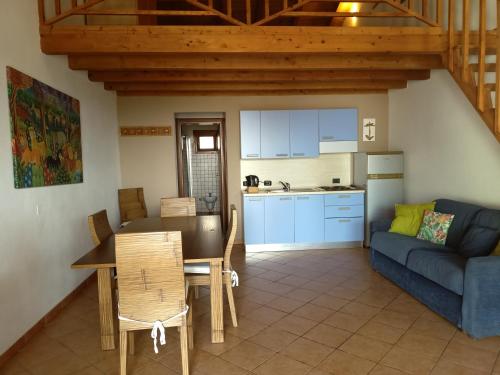 a kitchen and a living room with a couch and a table at Sal&Love apt in Porto Antigo in Santa Maria