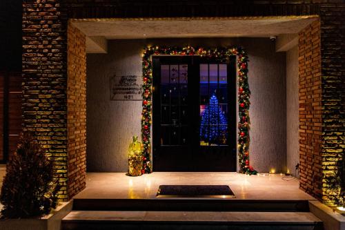 a door with a christmas tree in front of it at Boutique Hotel Kviria in Tʼelavi