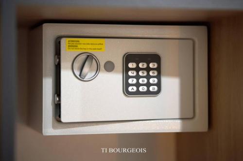 a remote control is attached to a wall at Le Ti Bourgeois in Rivière-Salée