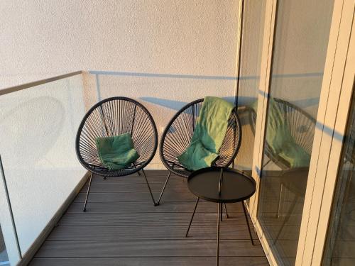 a couple of chairs sitting on a balcony at UniQue 106 in Gdynia