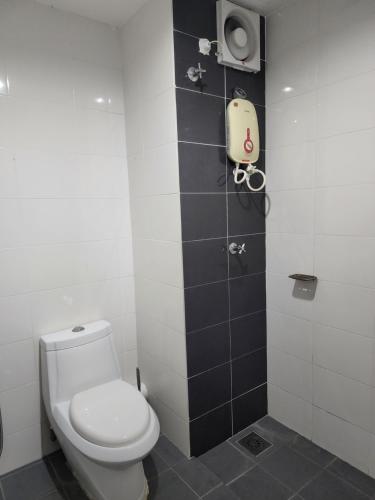 a bathroom with a white toilet and a shower at The Viana Apartment 6 in Kota Bharu