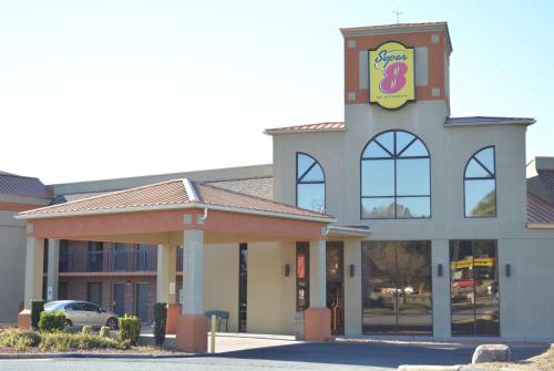 a fast food restaurant with a building with a sign on it at Super 8 by Wyndham Huntersville/Charlotte Area in Huntersville