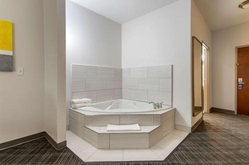 a bathroom with a bath tub in a room at Comfort Suites Natchitoches in Natchitoches